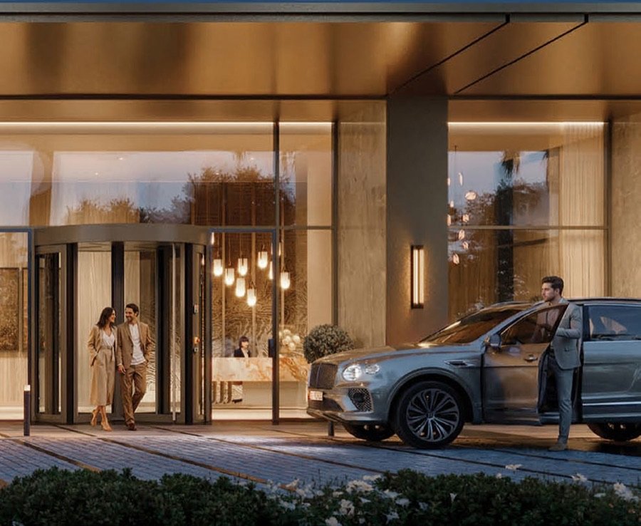 The porte-cochère at dusk, a car at the entrance