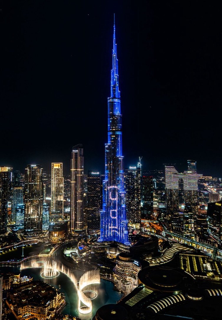 The Burj Khalifa lit blue above Downtown Dubai at night
