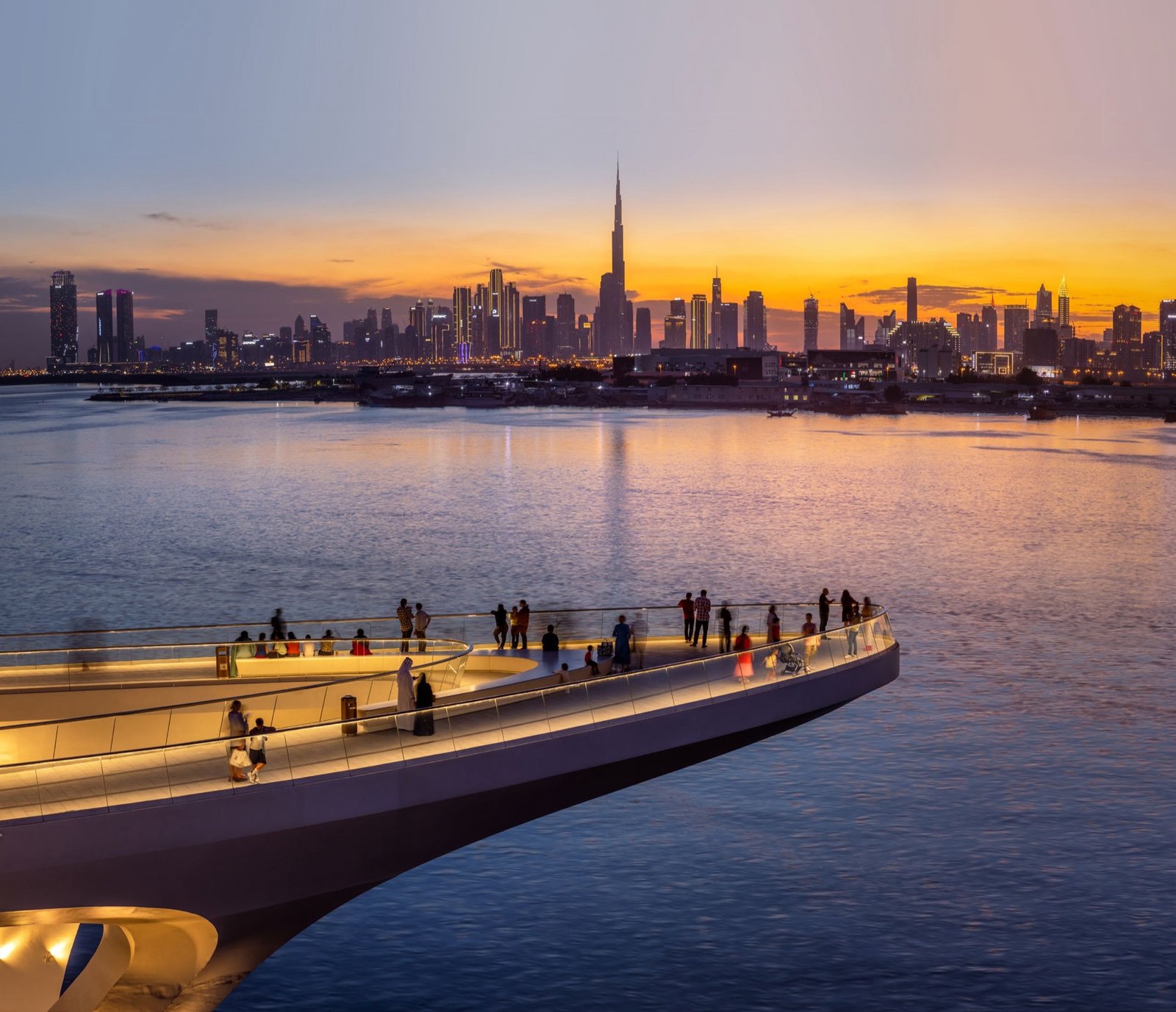 The Creek Harbour promenade at sunset, the Dubai skyline beyond