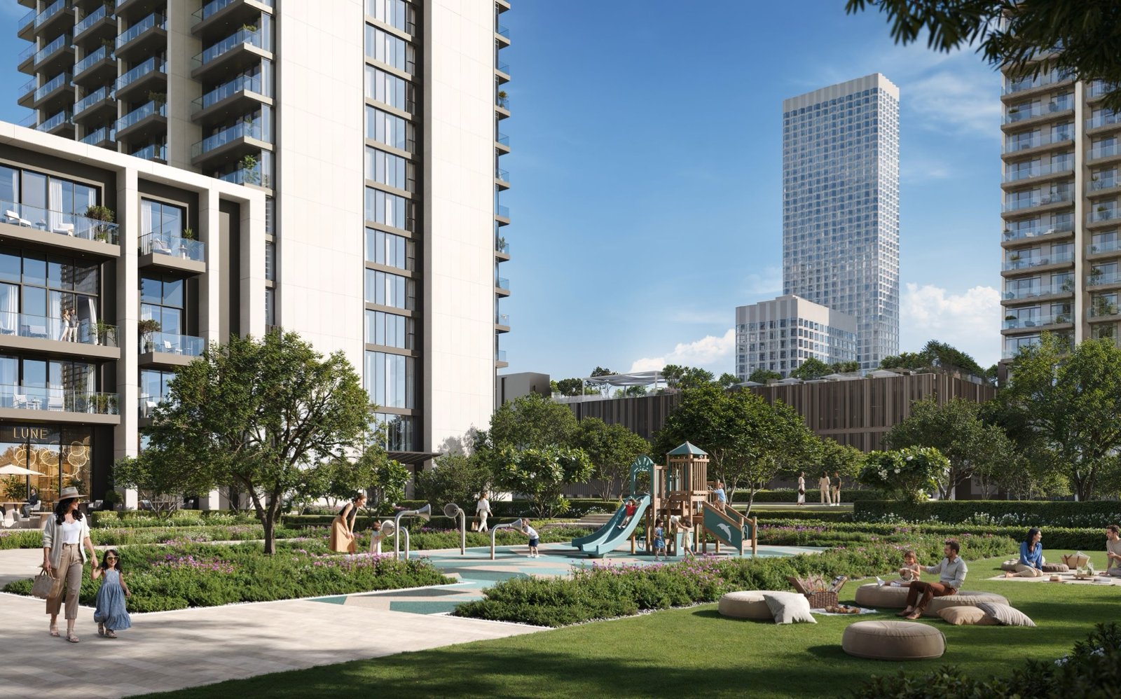 The linear park at ground level, play area and lawn between the towers
