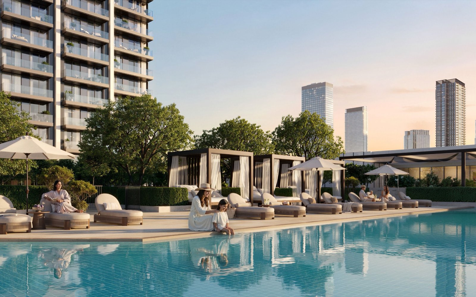 The pool deck at sunset, cabanas and loungers along the water